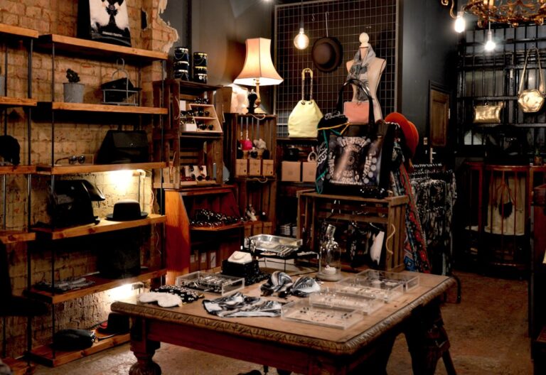 Cozy retail store with neatly organized shelves and tables displaying accessories, highlighting a tidy and inviting shopping environment.